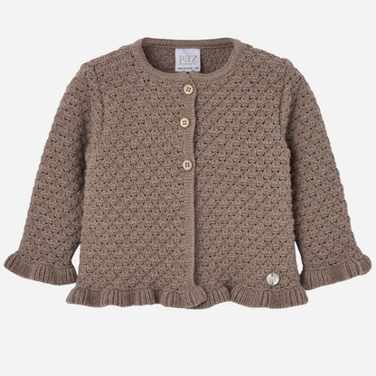 Sold at Bombon shop, designed by Paz Rodriguez. Brown knit baby cardigan with textured finish, wooden buttons, and ruffled trim.