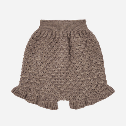 Sold at Bombon shop, designed by Paz Rodriguez. Brown knit baby shorts with ruffled hem and textured pattern.