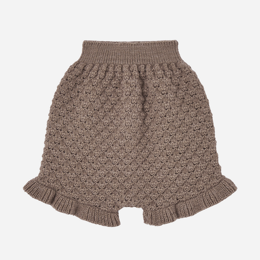 Sold at Bombon shop, designed by Paz Rodriguez. Brown knit baby shorts with ruffled hem and textured pattern.