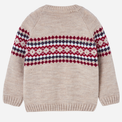 Sold at Bombon shop, designed by Paz Rodriguez. Beige knit sweater with red, navy, and ivory Nordic pattern across chest and sleeves.