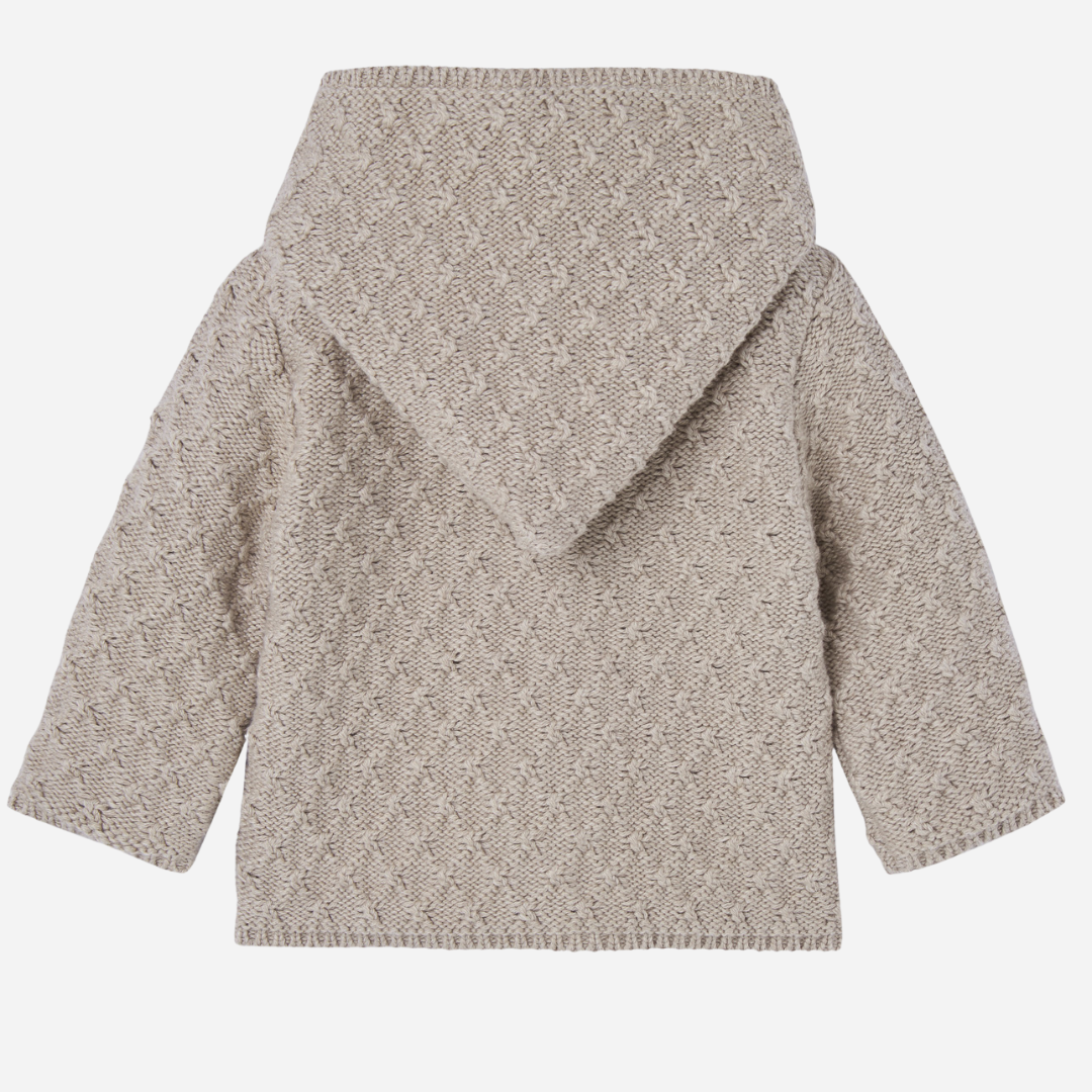 Sold at Bombon shop, designed by Paz Rodriguez, beige knit baby coat with hood and cotton lining printed with ponies.