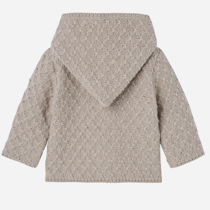 Sold at Bombon shop, designed by Paz Rodriguez, beige knit baby coat with hood and cotton lining printed with ponies.