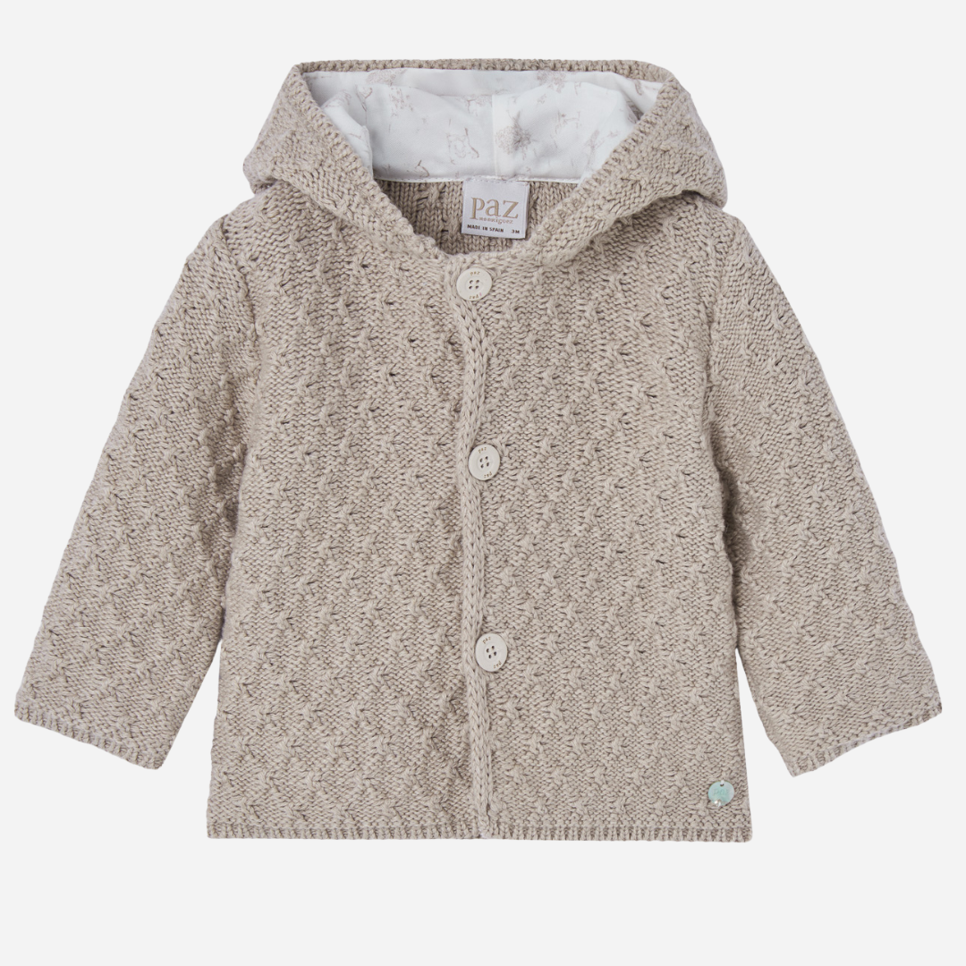 Sold at Bombon shop, designed by Paz Rodriguez, beige knit baby coat with hood and cotton lining printed with ponies.