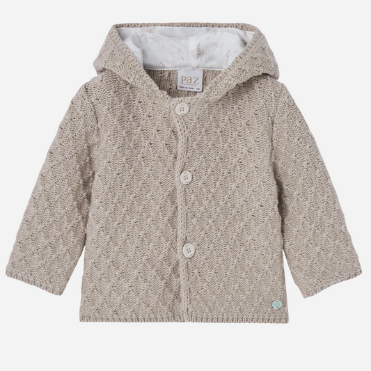 Sold at Bombon shop, designed by Paz Rodriguez, beige knit baby coat with hood and cotton lining printed with ponies.