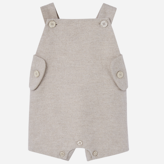 Sold at Bombon shop, designed by Paz Rodriguez. Beige herringbone baby overall with buttoned straps and side flap details.