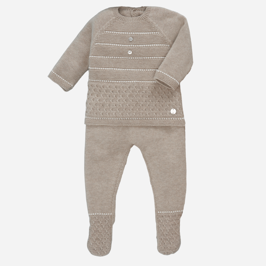 Sold at Bombon shop, designed by Paz Rodriguez, beige knit baby set with patterned sweater and matching footed pants.