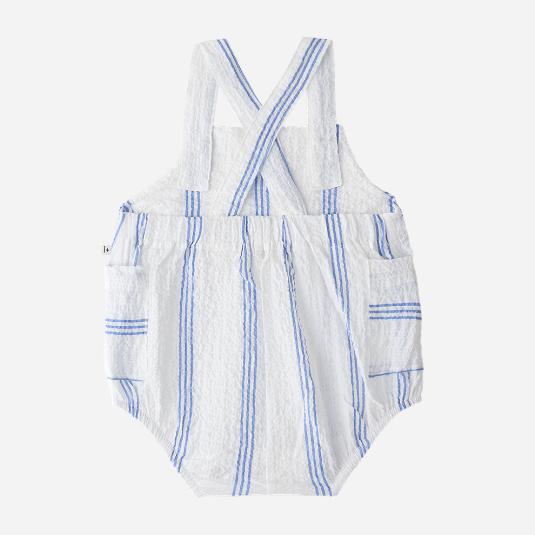 Sold at Bombon Shop, designed by 1+ in the family, ultramarine striped baby romper with adjustable straps and lightweight cotton fabric.
