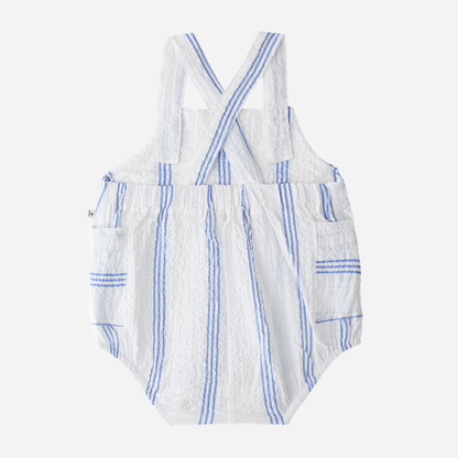 Sold at Bombon Shop, designed by 1+ in the family, ultramarine striped baby romper with adjustable straps and lightweight cotton fabric.