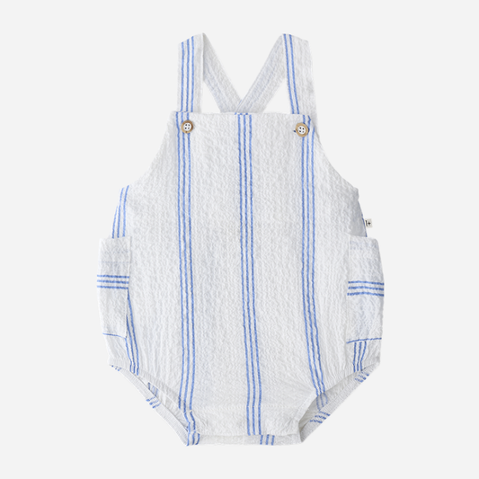 Sold at Bombon Shop, designed by 1+ in the family, ultramarine striped baby romper with adjustable straps and lightweight cotton fabric.