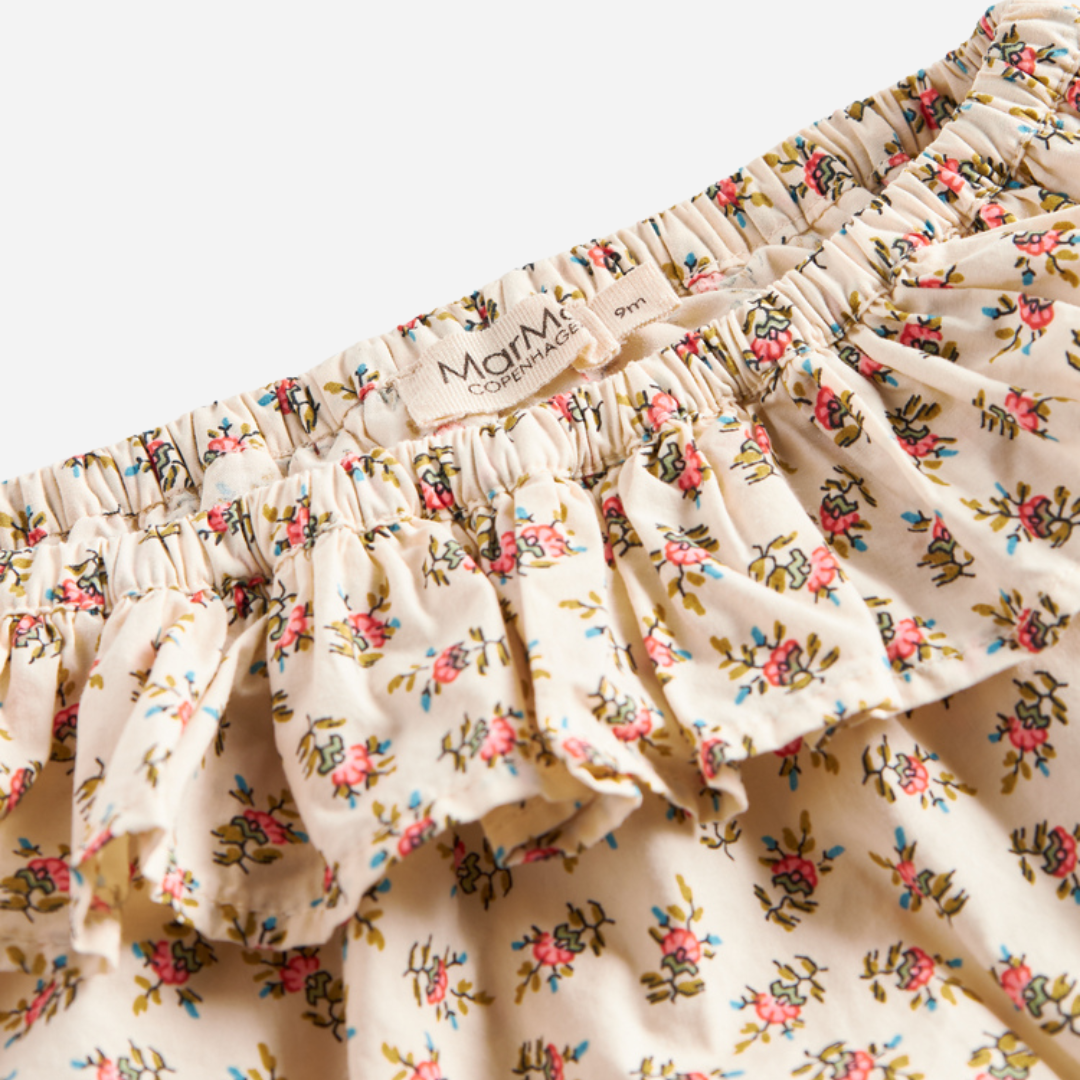Sold at Bombon shop, designed by MarMar Copenhagen — floral cotton baby bloomers with ruffled waist, pairs perfectly with matching floral blouse.