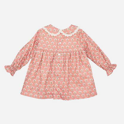 Sold at Bombon shop, designed by Fina Ejerique, a coral-pink floral baby dress with lace-trim collar and long sleeves. back