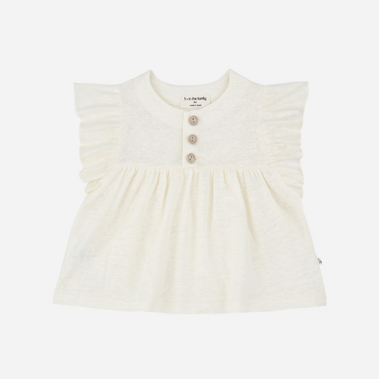 Sold at Bombon shop, designed by 1+ in the family brand, this white blouse for baby girls and toddlers is ideal for spring and summer. front view