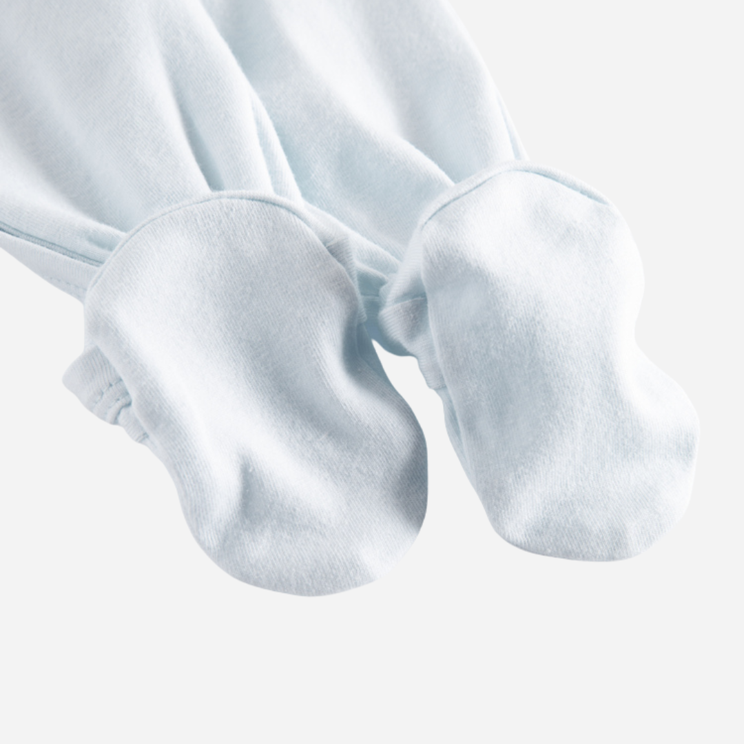 Sold at Bombon shop, designed by MarMar Copenhagen — powder blue organic cotton footed baby onesie with side tie closure.