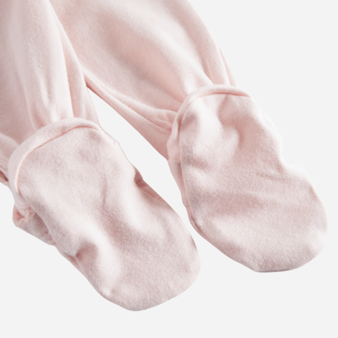 Sold at Bombon shop, designed by MarMar Copenhagen — blush pink organic cotton footed baby onesie with side tie closure.