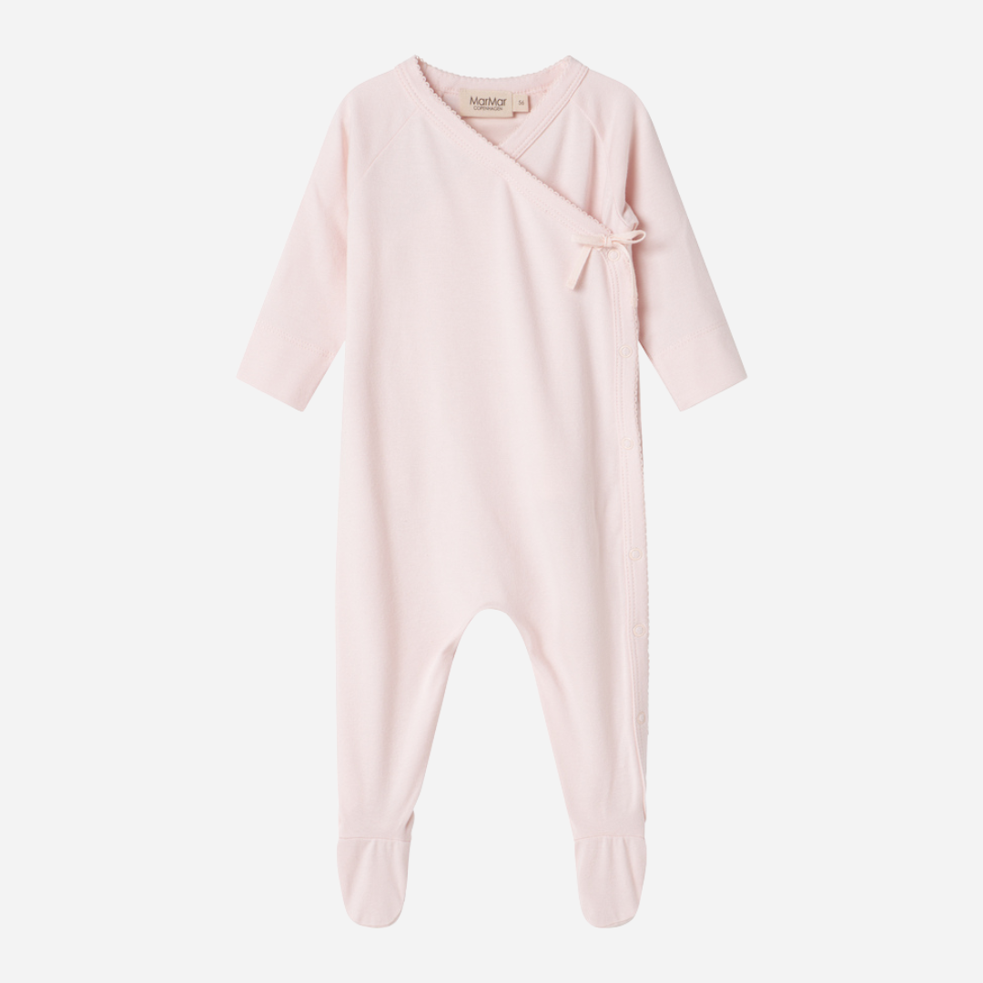 Sold at Bombon shop, designed by MarMar Copenhagen — blush pink organic cotton footed baby onesie with side tie closure.