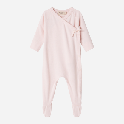 Sold at Bombon shop, designed by MarMar Copenhagen — blush pink organic cotton footed baby onesie with side tie closure.