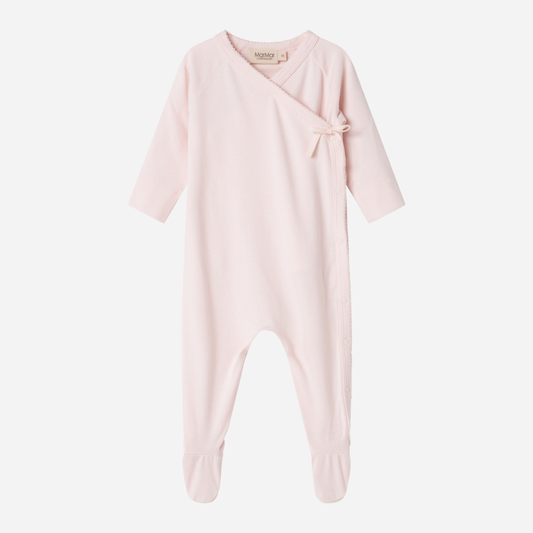Sold at Bombon shop, designed by MarMar Copenhagen — blush pink organic cotton footed baby onesie with side tie closure.