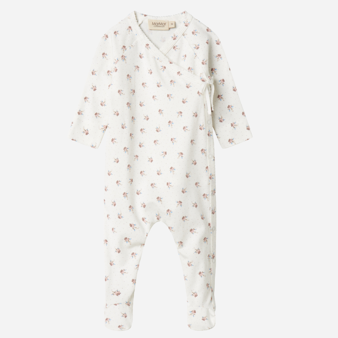 Sold at Bombon shop, designed by MarMar Copenhagen — white organic cotton baby onesie with floral print and side-tie closure, part of a matching set.