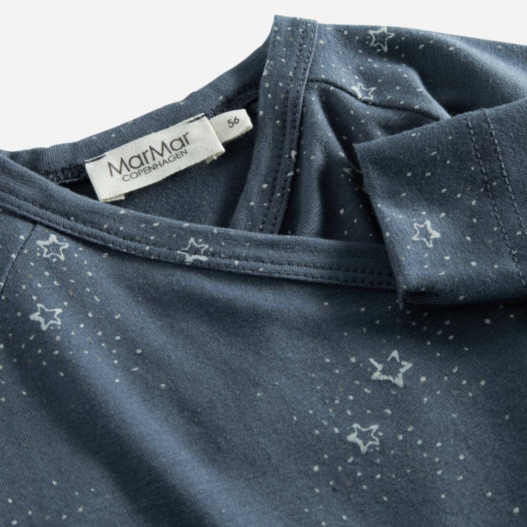Sold at Bombon shop, designed by MarMar Copenhagen. Midnight blue baby wrap footie with white star print, pairs perfectly with the matching hat and blanket.