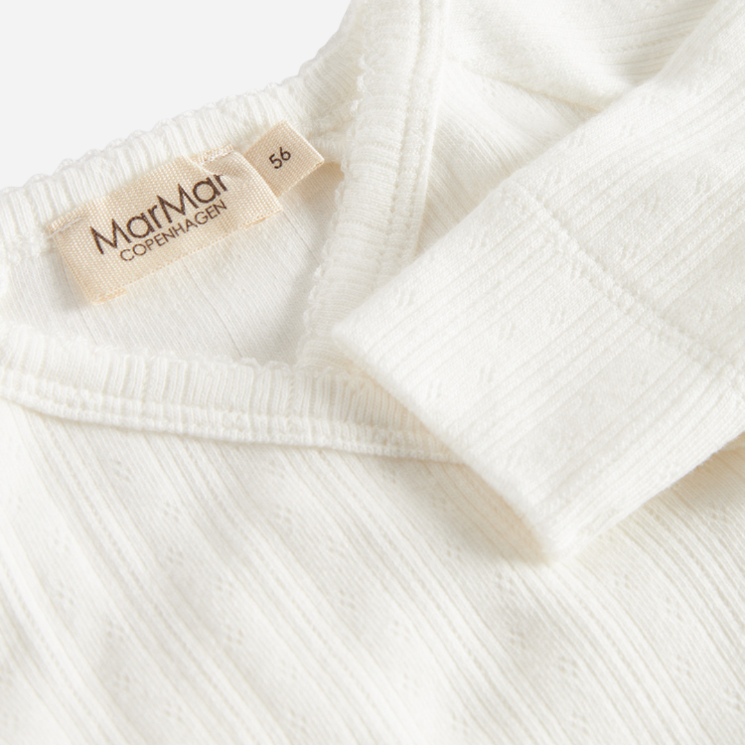 Sold at Bombon shop, designed by MarMar Copenhagen. Cream white ribbed baby wrap footie with side tie, pairs perfectly with the matching hat and blanket.