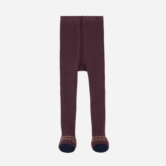 Sold at Bombon shop, designed by 1+ in the family — ribbed knit baby tights in melanzana with contrast navy toes and tan stripe detail.