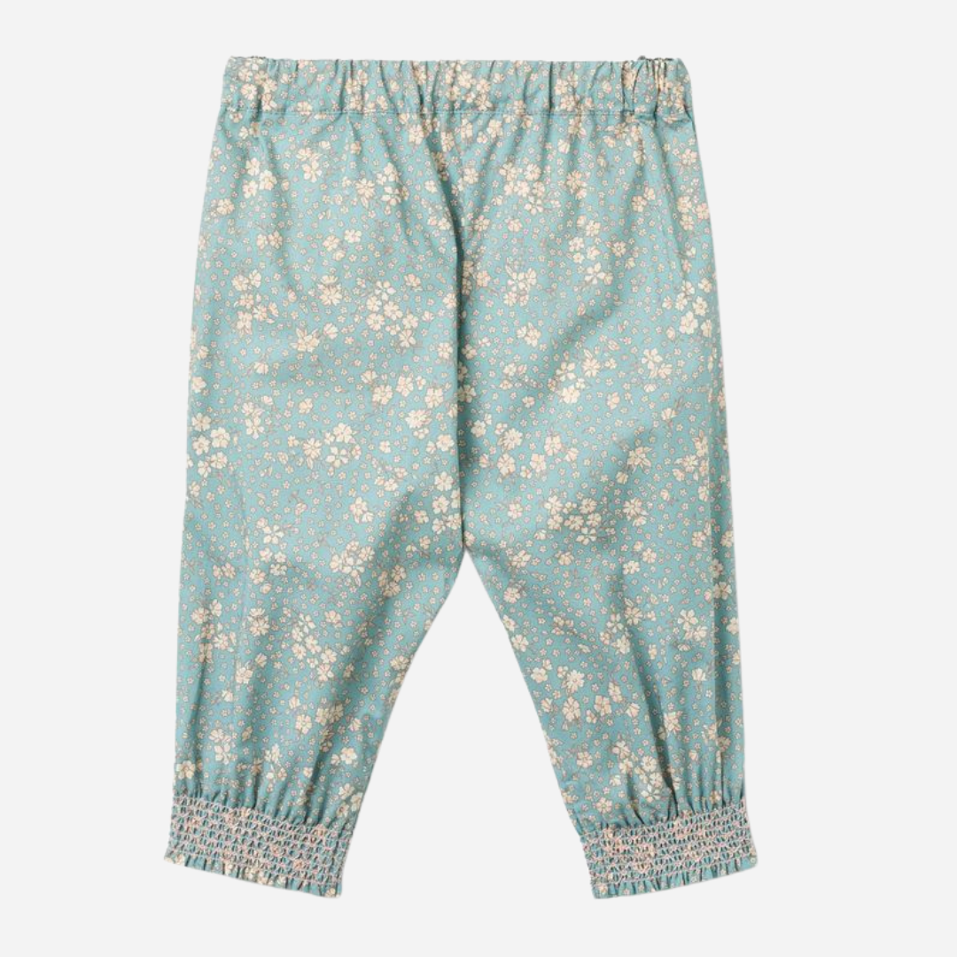 Sold at Bombon Shop, designed by Wheat, spring lake flowers organic cotton baby trousers in soft blue floral print with elastic waist and relaxed fit.