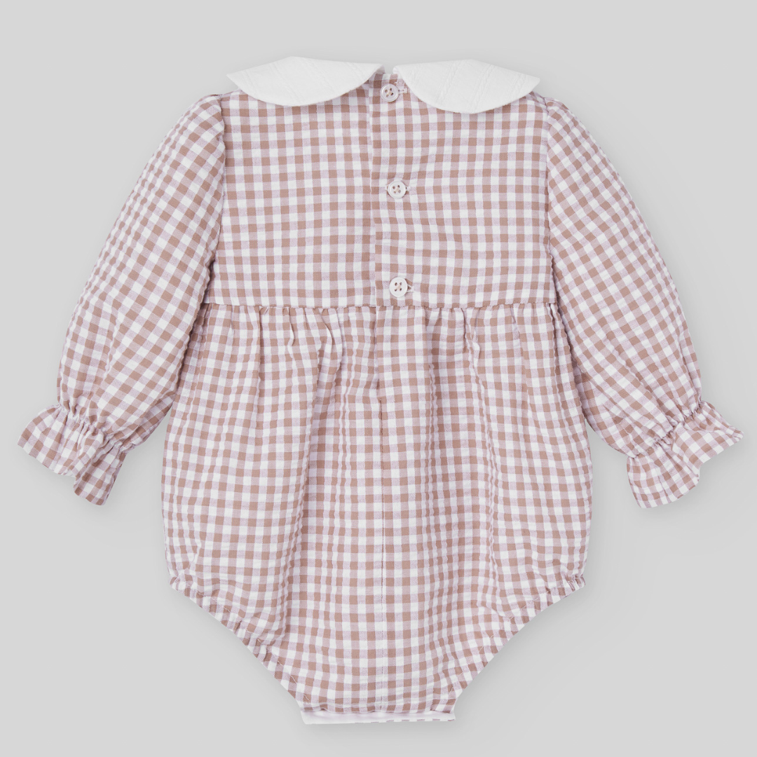 Sold at Bombon shop, designed by Paz Rodriguez, beige gingham baby romper with white collar and long sleeves.