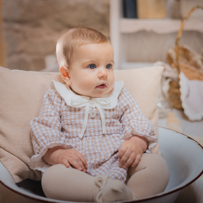 Sold at Bombon shop, designed by Paz Rodriguez, beige gingham baby romper with white collar and long sleeves.