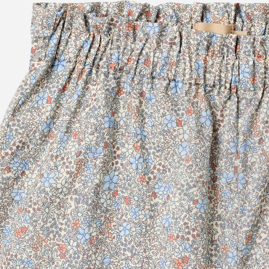 Sold at Bombon Shop, designed by Wheat, air blue flowers organic cotton baby shorts with lace hem detail and elastic waistband.