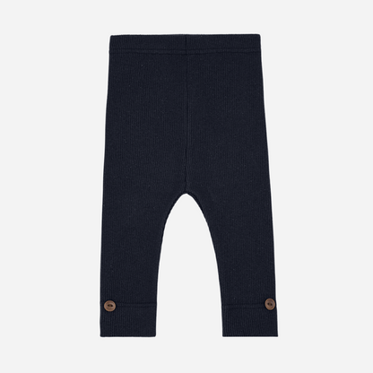 Sold at Bombon shop, designed by 1+ in the family — navy ribbed leggings with wooden button detail at ankle.