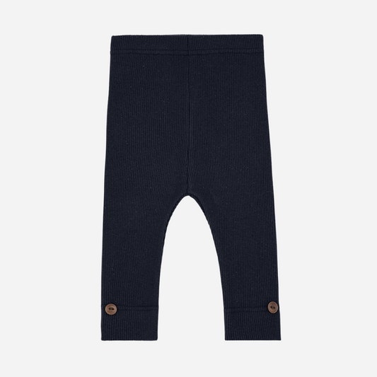 Sold at Bombon shop, designed by 1+ in the family — navy ribbed leggings with wooden button detail at ankle.