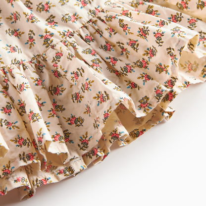 Sold at Bombon shop, designed by MarMar Copenhagen — floral cotton baby skirt with ruffled hem and elastic waistband, pairs perfectly with the matching knit cardigan.