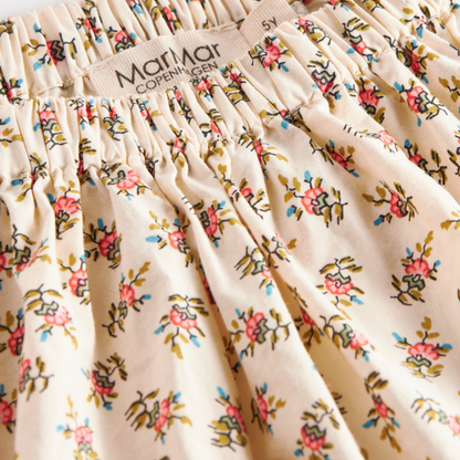 Sold at Bombon shop, designed by MarMar Copenhagen — floral cotton baby skirt with ruffled hem and elastic waistband, pairs perfectly with the matching knit cardigan.