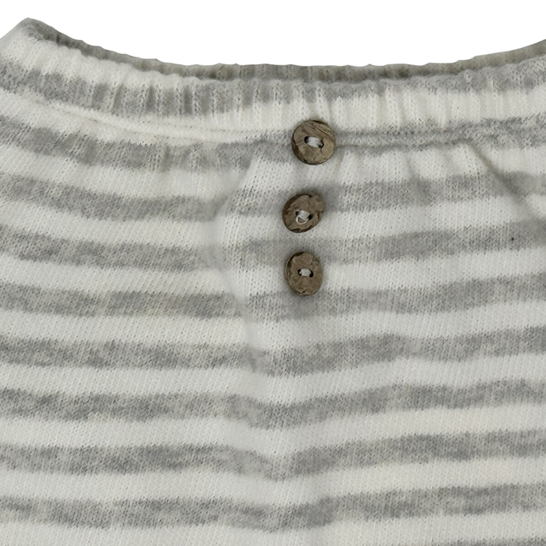 Sold at Bombon shop, designed by Tiny Soul — baby pants in grey and white stripes with elastic waistband, button accents, and rolled cuffs. detail