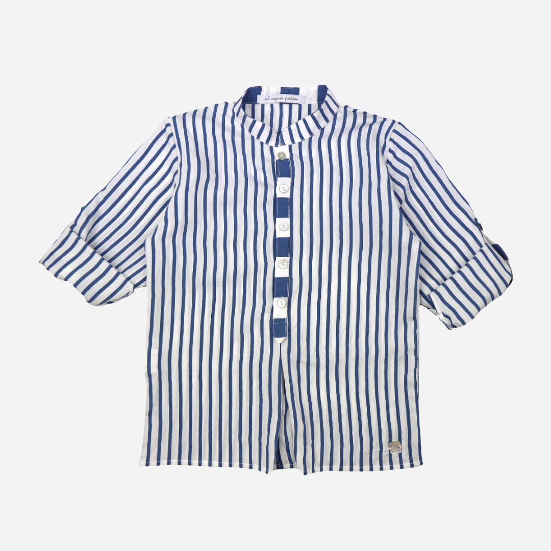 Sold at Bombon shop, designed by Al Agua Patos brand, this blue and white striped shirt for baby boys and toddlers perfect for spring and summer. rolled sleeves