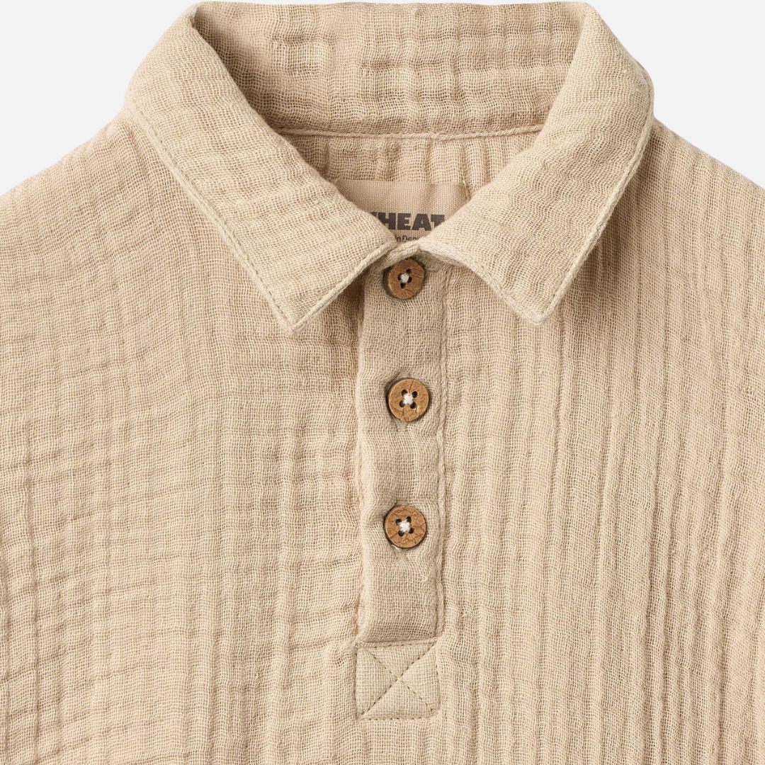 Sold at Bombon Shop, designed by Wheat, warm sand organic cotton short sleeve shirt with soft textured fabric and classic collar.