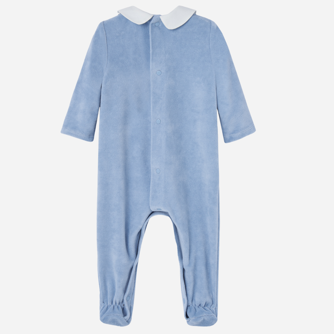 Sold at Bombon shop, designed by Paz Rodriguez. Baby boy footed velour jumpsuit in sky blue with white Peter Pan collar and embroidered chest detail.