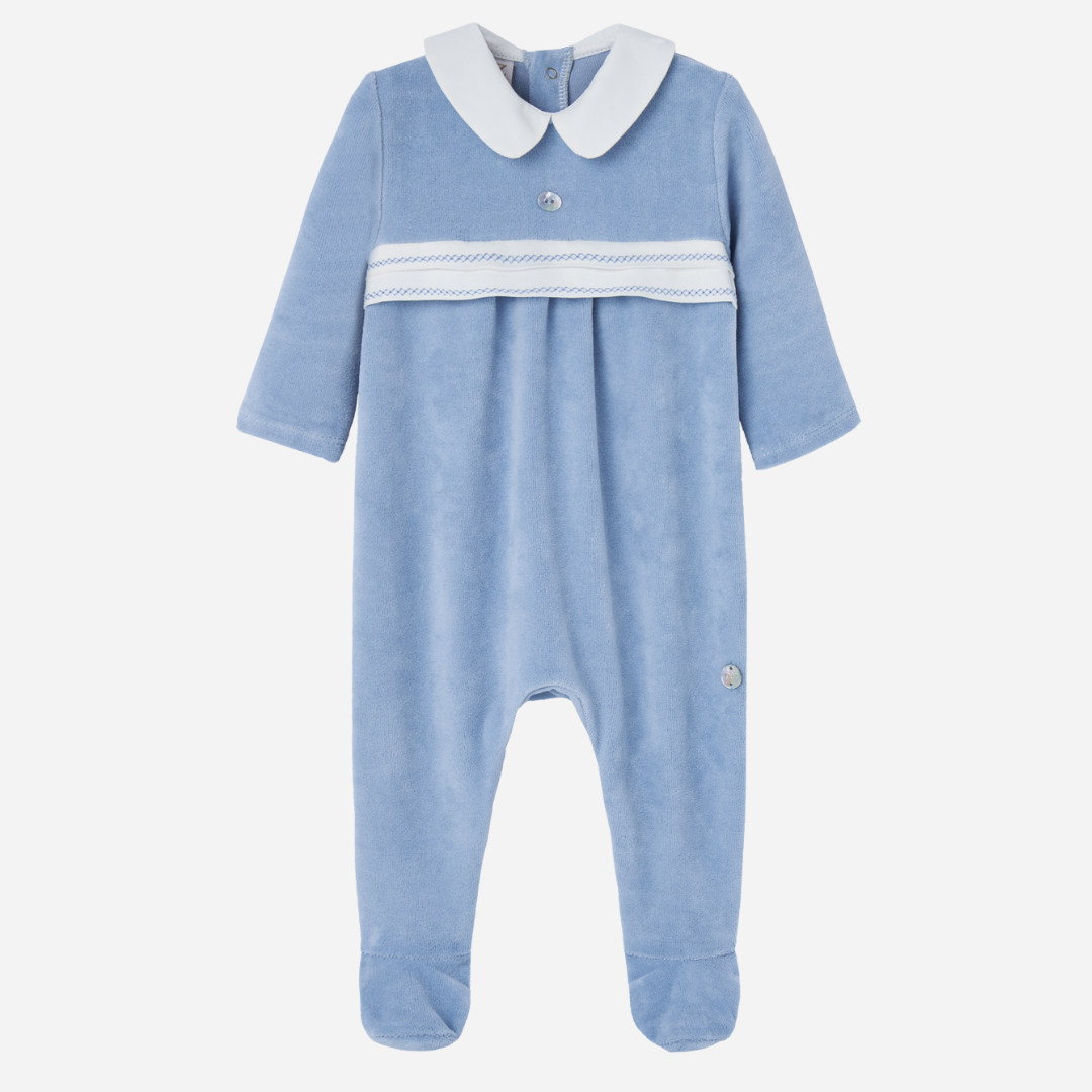 Sold at Bombon shop, designed by Paz Rodriguez. Baby boy footed velour jumpsuit in sky blue with white Peter Pan collar and embroidered chest detail.