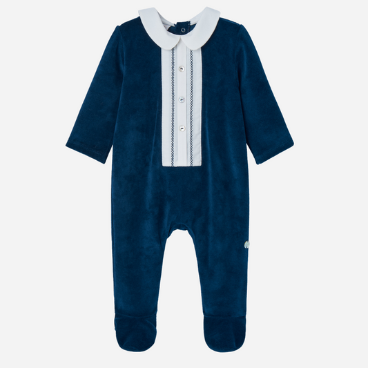 Sold at Bombon shop, designed by Paz Rodriguez, navy velour baby jumpsuit with white collar and embroidered front panel
