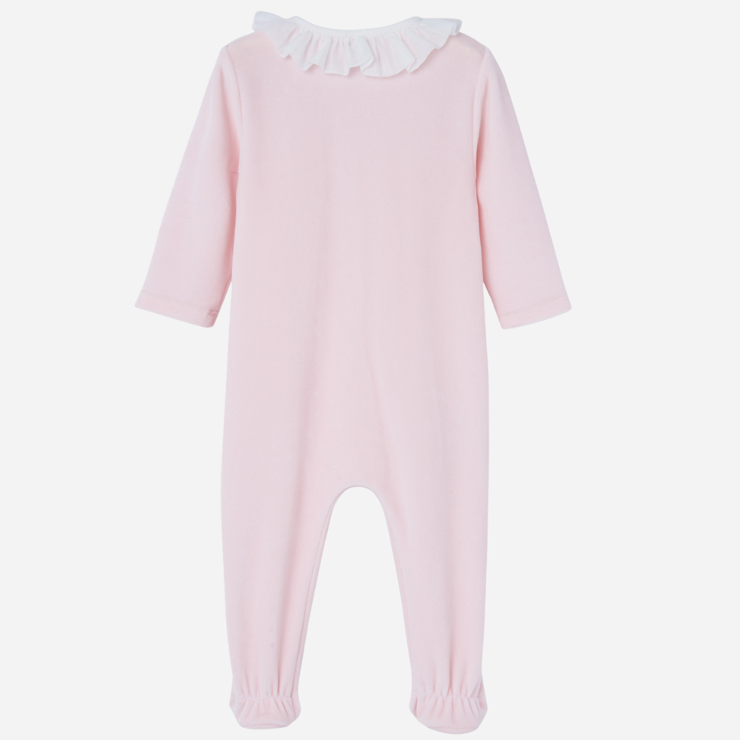 Sold at Bombon shop, designed by Paz Rodriguez. Baby girl footed velour jumpsuit in blush pink with ivory lace trim and ruffled collar.