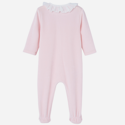 Sold at Bombon shop, designed by Paz Rodriguez. Baby girl footed velour jumpsuit in blush pink with ivory lace trim and ruffled collar.