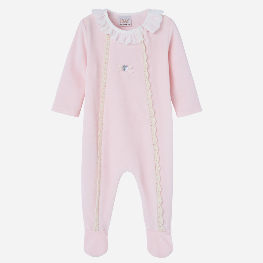 Sold at Bombon shop, designed by Paz Rodriguez. Baby girl footed velour jumpsuit in blush pink with ivory lace trim and ruffled collar.