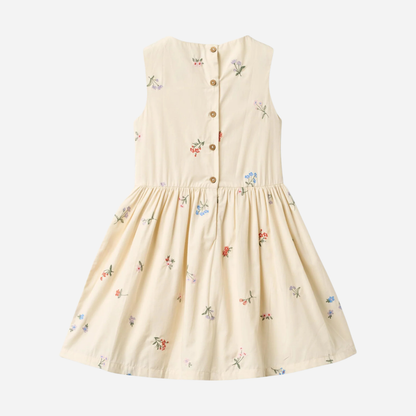 Sold at Bombon Shop, designed by Wheat, ivory organic cotton sleeveless dress with embroidered flowers and softly pleated skirt.