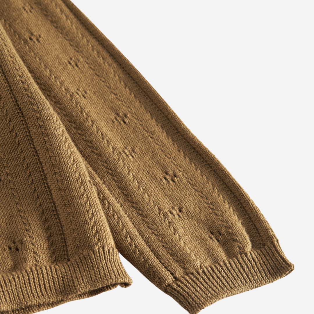 Sold at Bombon shop, designed by MarMar Copenhagen — golden brown cotton knit baby cardigan with bow tie collar and pointelle details, pairs perfectly with the floral skirt.