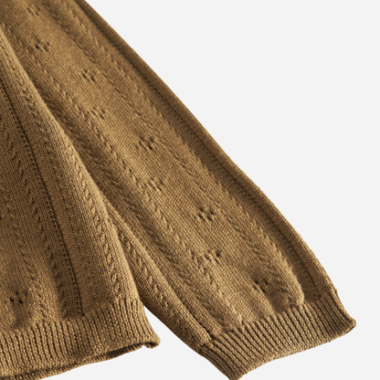 Sold at Bombon shop, designed by MarMar Copenhagen — golden brown cotton knit baby cardigan with bow tie collar and pointelle details, pairs perfectly with the floral skirt.