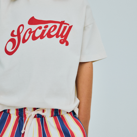 sold at Bombon, designed by The New Society kids ecru t-shirt with society graphic in 100% cotton relaxed fit pairs with striped gorse pants