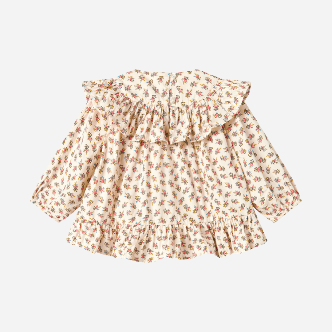 Sold at Bombon shop, designed by MarMar Copenhagen — floral cotton baby blouse with ruffled collar and hem, pairs perfectly with matching floral bloomers.