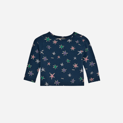 Sold at Bombon shop, this baby girl tee by The New Society features a navy base with an all-over colorful star print, long sleeves, and a soft jersey fabric for everyday comfort with a playful twist. front