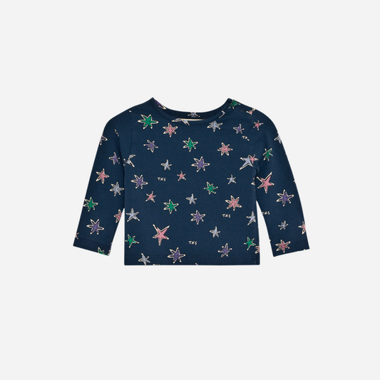 Sold at Bombon shop, this baby girl tee by The New Society features a navy base with an all-over colorful star print, long sleeves, and a soft jersey fabric for everyday comfort with a playful twist. front