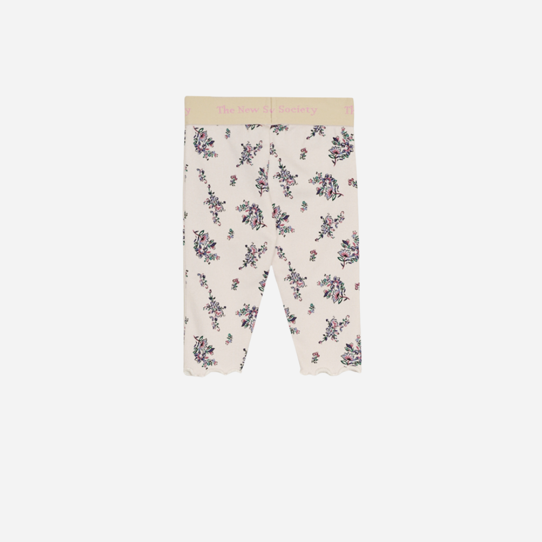 Sold at Bombon shop, these baby and toddler girl leggings by The New Society feature a soft cream base with an all-over floral print, a comfortable elastic waistband with logo detail, and a delicate lettuce-edge hem for a sweet everyday essential. back
